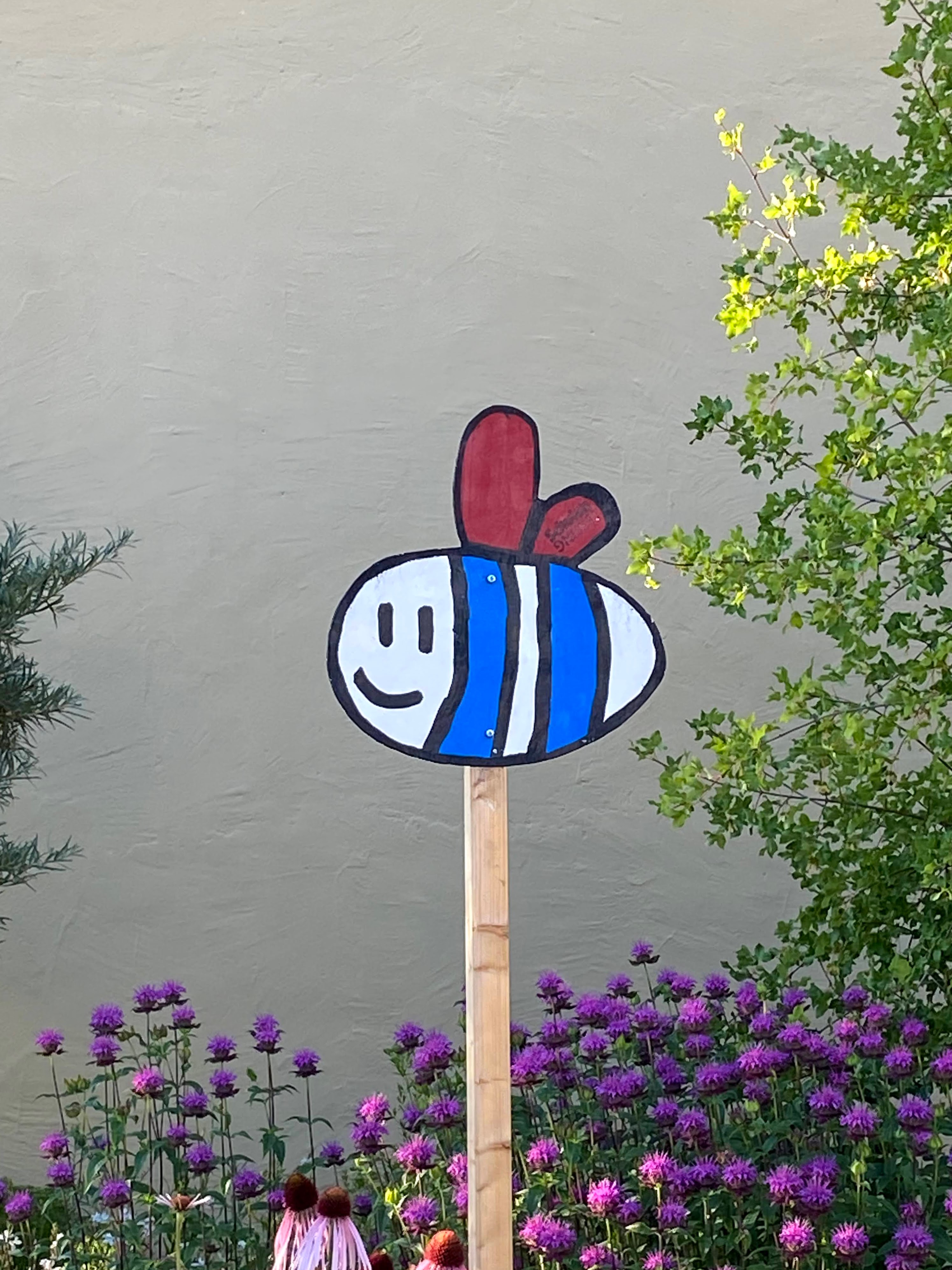 N/A (Image depicts a cartoon bee sign, not a butterfly or moth)