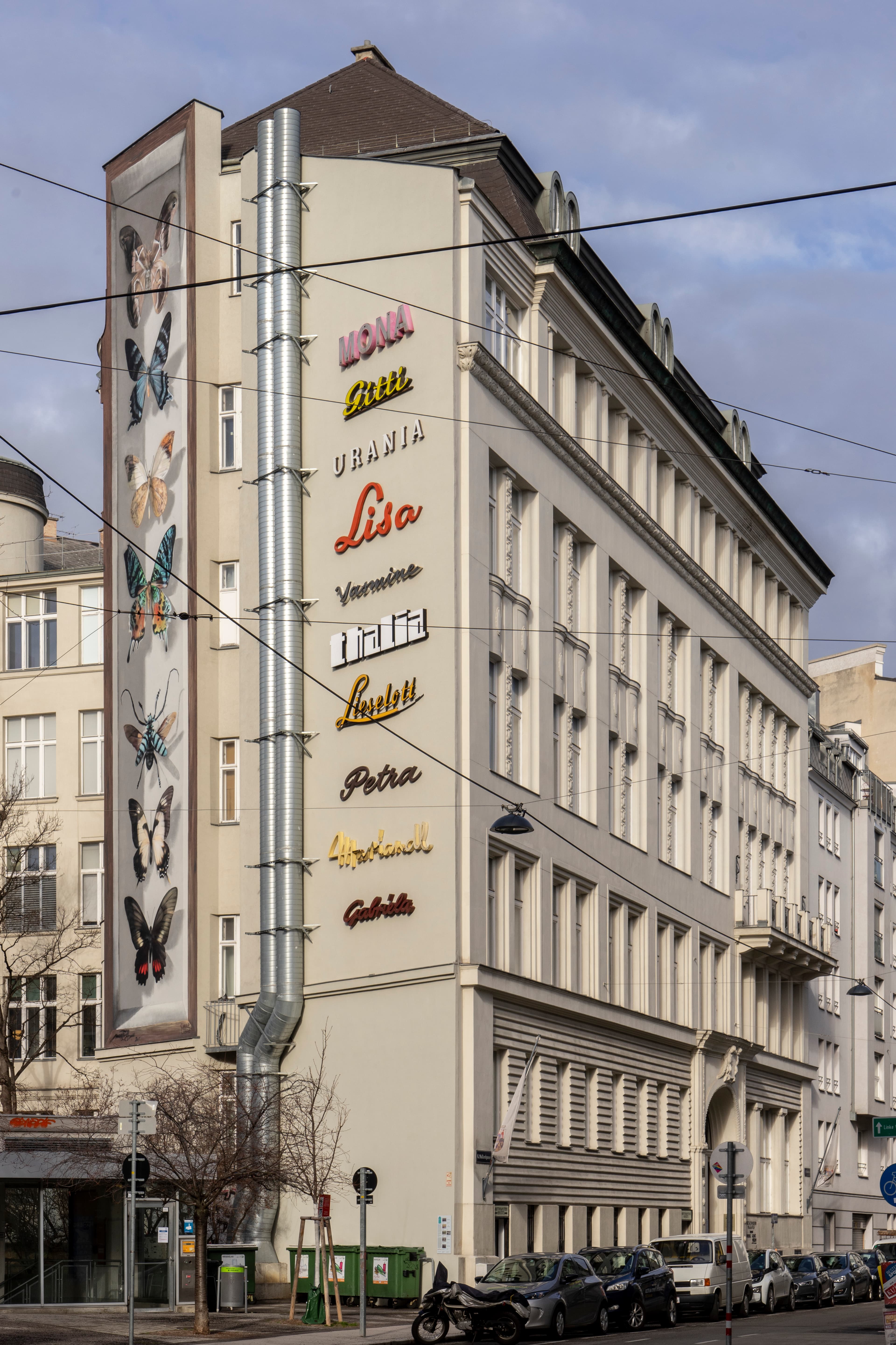 Not Applicable (Image depicts building murals, not a specific butterfly species)